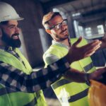 Portrait of construction engineers working on building site